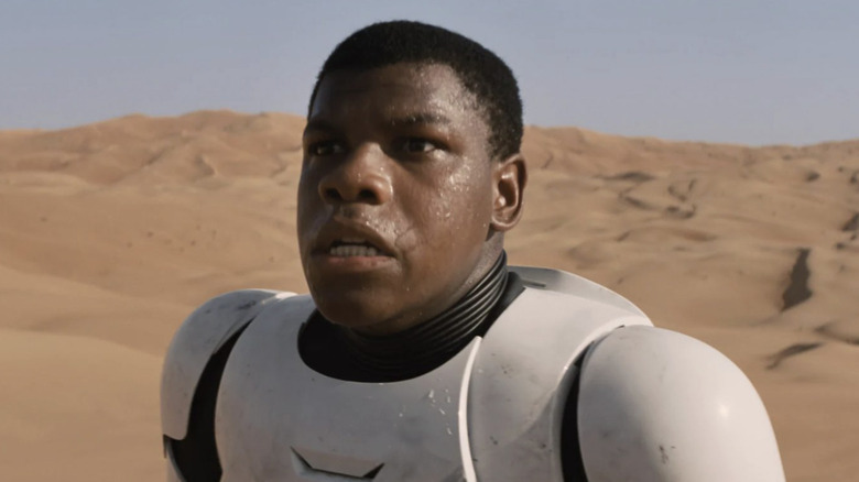 John Boyega as FN-2187 AKA Finn sweating on the desert planet Jakku wearing a stormtrooper suit in Star Wars: The Force Awakens.