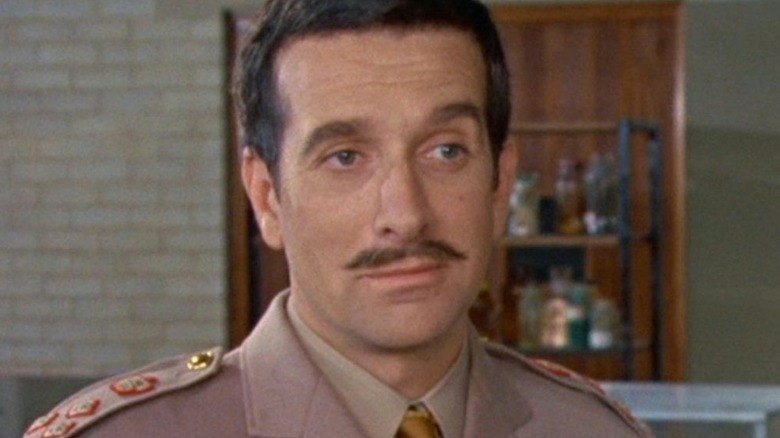 Brigadier Lethbridge-Stewart (Nicholas Courtney) smirks in a lab in Doctor Who