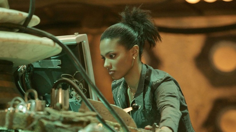 Martha Jones (Freema Agyeman) inspects the TARDIS console in Doctor Who