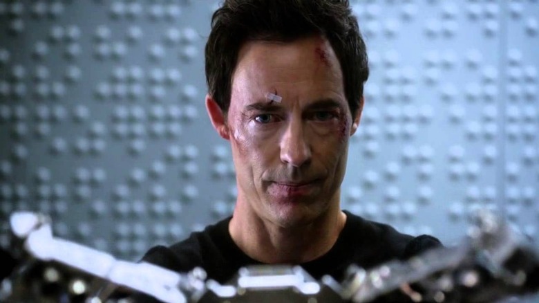 Tom Cavanagh as Eobard Thawne, adding a device to the Reverse Flash suit on The Flash
