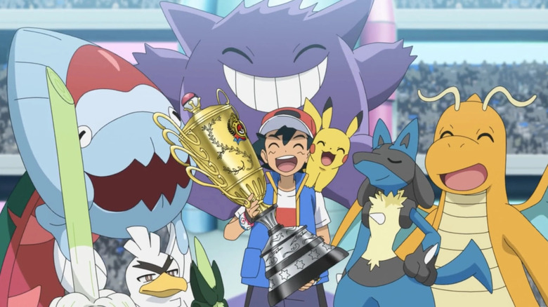 Ash holding a trophy with his champion team, including Sirfetch'd, Dracovish, Gengar, Pikachu, Lucario, and Dragonite