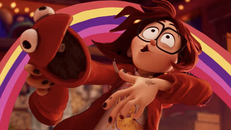 Katie Mitchell (Abbi Johnson) leans back holdinga sock puppet in The Mitchells vs. the Machines