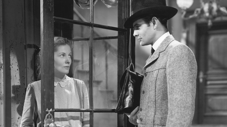 Joan Fontaine and Louis Jourdan staring glass door Letter from an Unknown Woman