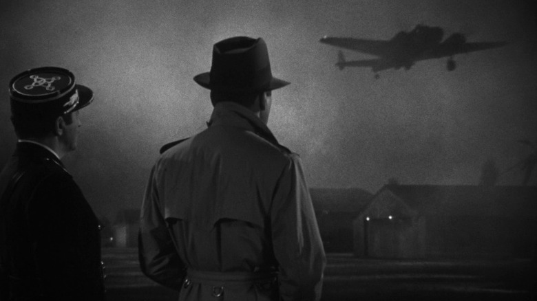 Louis Renault (Claude Rains) and Rick Blaine (Humphrey Bogart) watch a plane fly away in Casablanca