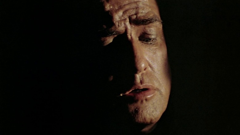 Walter Kurtz (Marlon Brando) speaks in the shadows in Apocalypse Now