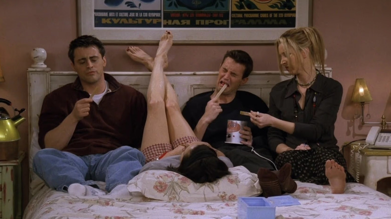 Matt LeBlanc as Joey Tribbiani, Courteney Cox as Monica Geller, Matthew Perry as Chandler Bing, and Lisa Kudrow as Phoebe Buffay eating wax in the Friends episode "The One the Morning After"
