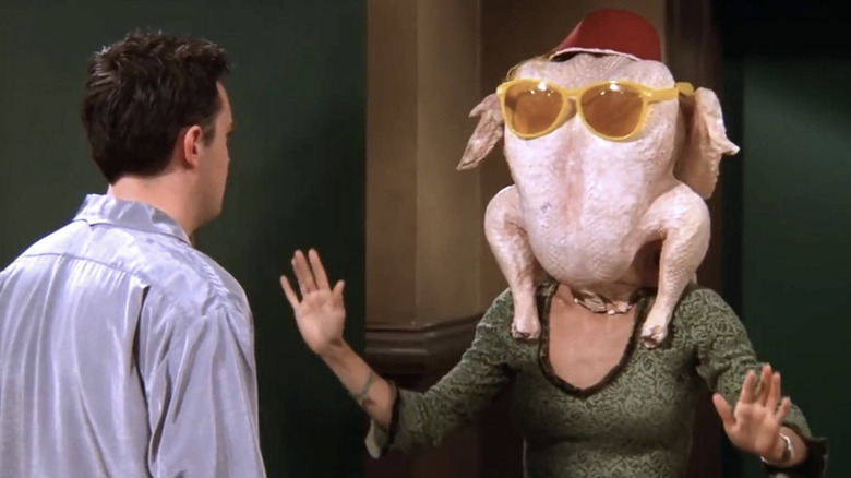 Matthew Perry as Chandler Bing and Courteney Cox as Monica Geller with a turkey on her head in the Friends episode "The One with All the Thanksgivings"