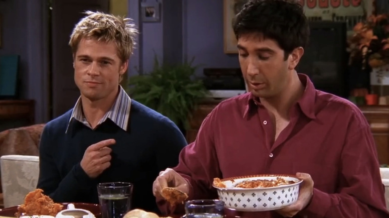 Brad Pitt as Will Colbert and David Schwimmer as Ross Geller eating Thanksgiving dinner in the Friends episode "The One with the Rumor"