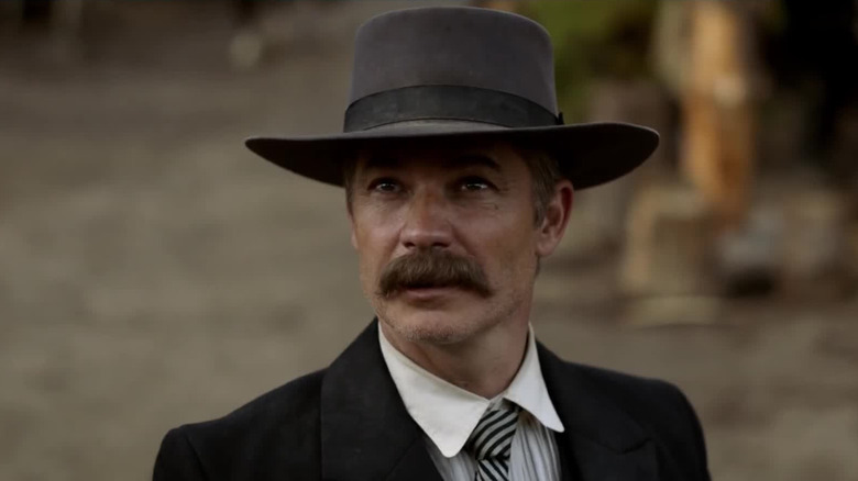 Timothy Olyphant as Seth Bullock, walking through town in Deadwood: The Movie