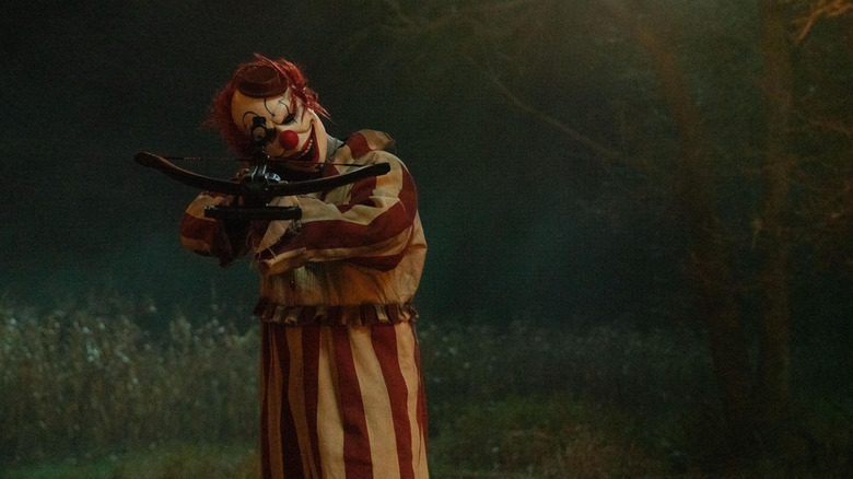 Frendo the clown holding a crossbow in Clown in a Cornfield