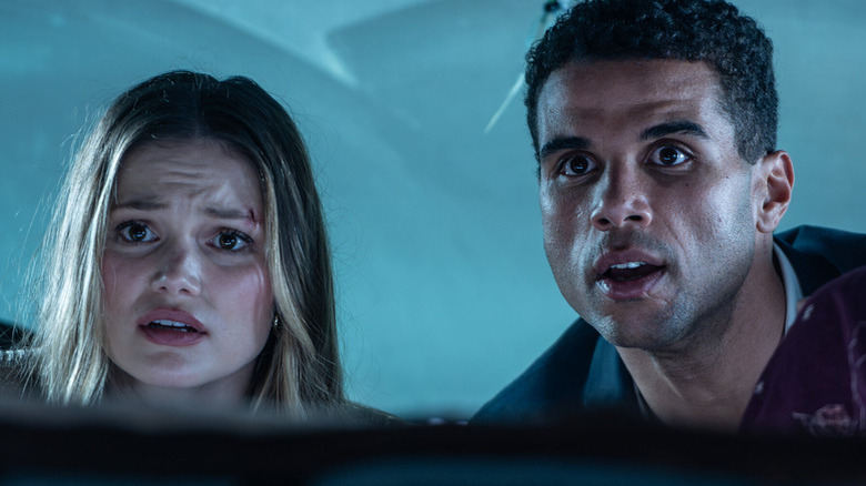 Ally (Olivia Holt) and Jay (Mason Gooding) hide in the back of a car in Heart Eyes