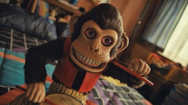 The monkey plays a tune on a bed in The Monkey