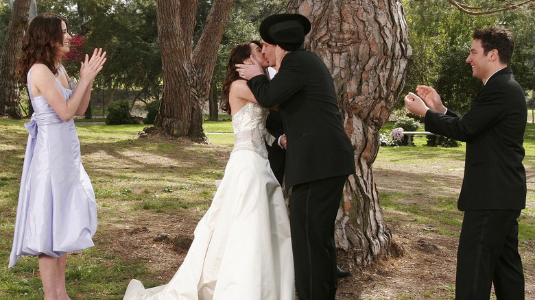 Lily Aldrin (Alyson Hannigan) and Marshall Eriksen (Jason Segel) kiss after getting married in a private ceremony in How I Met Your Mother