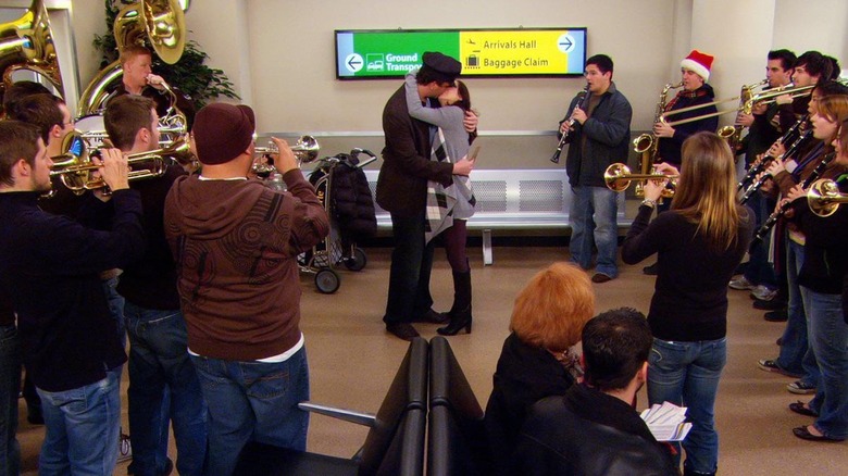 Marshall Eriksen (Jason Segel) and Lily Aldrin (Alyson Hannigan) embrace surrounded by the Fighting Hens Arizona State Marching Band in How I Met Your Mother