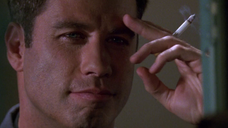 John Travolta as Major Vic "Deak" Deakins smoking a cigarette in Broken Arrow