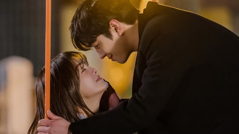 Kang Tae-moo (Ahn Hyo-seop) leans in to kiss Shin Ha-ri (Kim Se-jeong) in Business Proposal