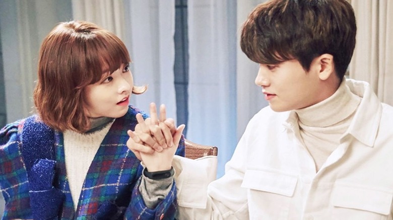 Do Bong-soon (Park Bo-young) holds hands with Ahn Min-hyuk (Park Hyung-sik) in Strong Girl Bong-soon