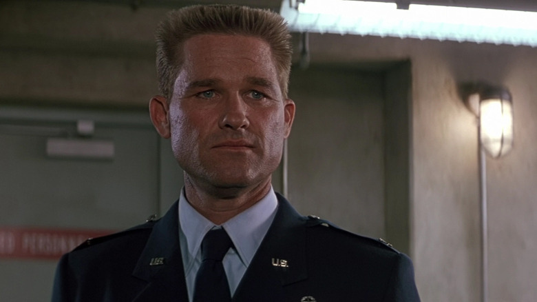 Kurt Russell as Colonel Jonathan J. "Jack" O'Neil standing in a lab in Stargate