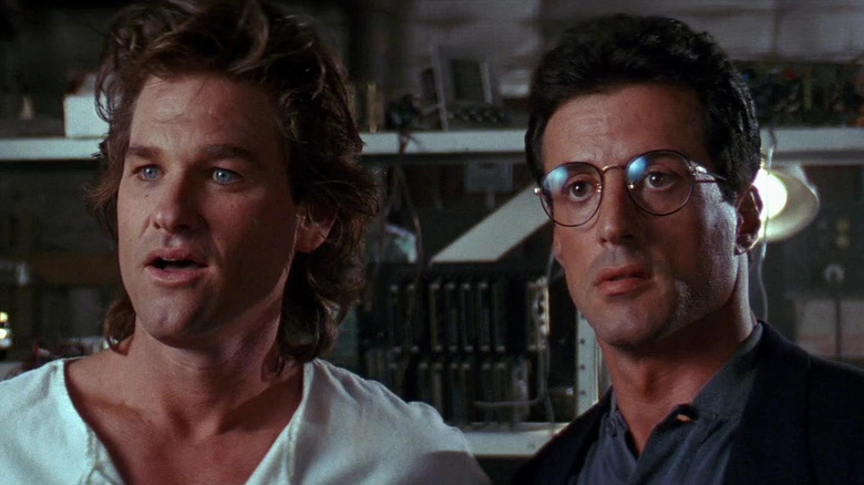 Kurt Russell as Lieutenant Gabriel "Gabe" Cash stands next to Sylvester Stallone as Lieutenant Raymond "Ray" Tango in Tango & Cash