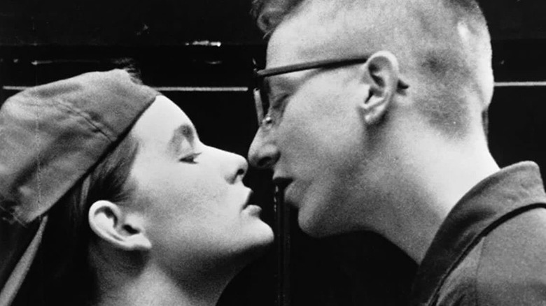 Guinevere Turner as Max with backwards baseball hat and V.S. Brodie as Ely with glasses and mohawk about to kiss