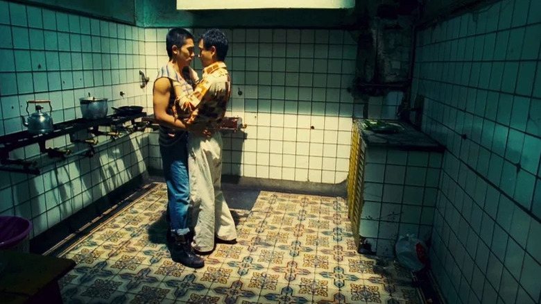 Leslie Cheung as Ho Po-Wing and Tony Leung Chiu-Wai as Lai Yiu-Fai embracing in a derelict kitchen in Happy Together