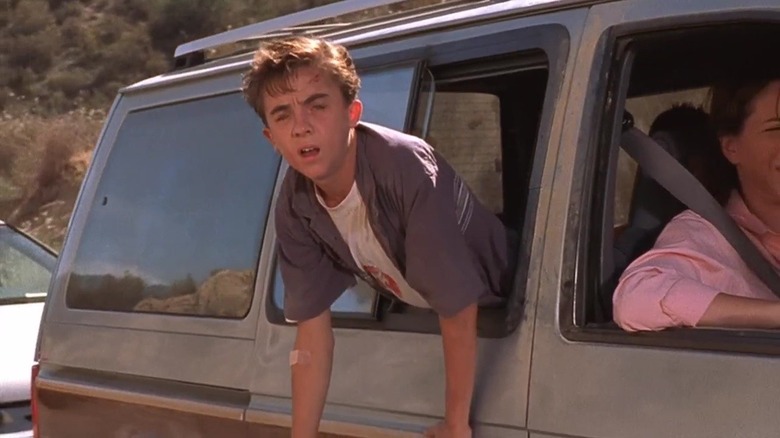 Malcolm (Frankie Muniz) hanging his head out a car window on Malcolm in the Middle