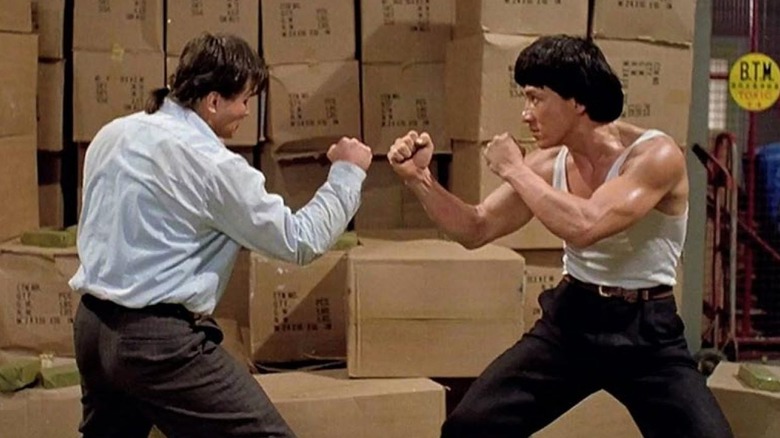 A technician (Benny Urquidez) and Jackie Lung (Jackie Chan) face each other in a warehouse in Dragons Forever