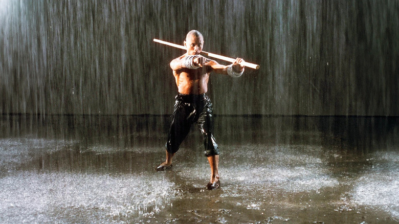 San Te (Gordon Liu) trains outside in the rain in The 36th Chamber of Shaolin