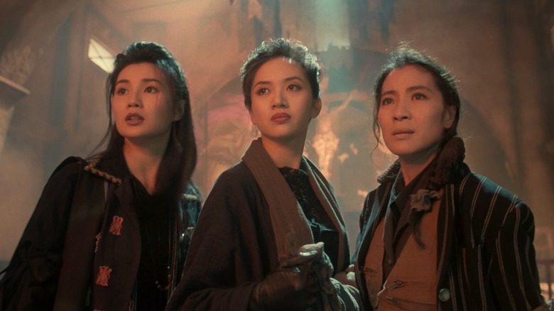 Chat (Maggie Cheung), Tung (Anita Mui), and Ching (Michelle Yeoh) stand in an underground lair in The Heroic Trio
