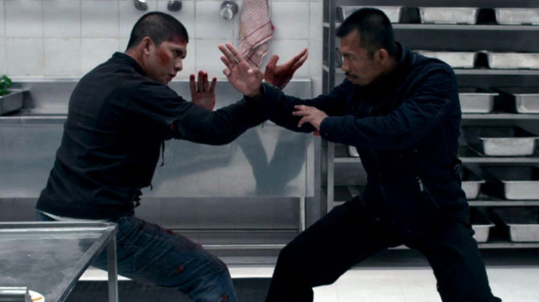 Rama (Iko Uwais) and the assassin (Cecep Arif Rahman) confront each other in a kitchen in The Raid 2