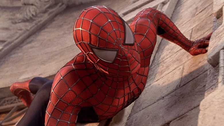 Tobey Maguire as Peter Parker/Spider-Man, wearing his suit and crawling on a wall.