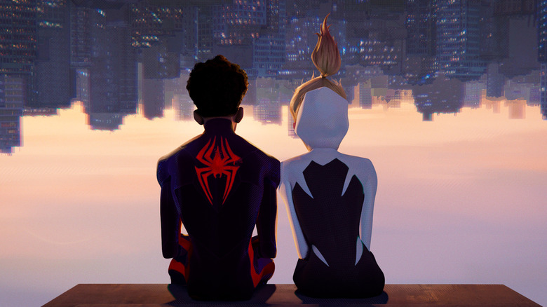 Shameik Moore as Miles Morales / Spider-Man and Hailee Steinfeld as Gwen Stacy / Spider-Gwen, sitting upside down and looking at the inverted cityscape.