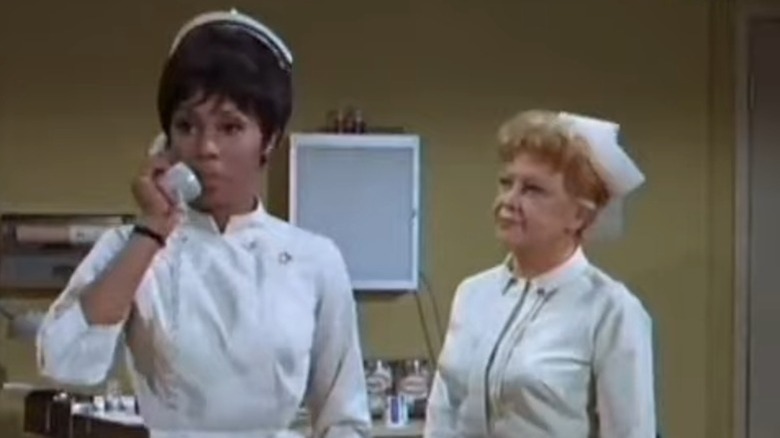 Diahann Carroll as Nurse Julia Baker talking on the phone while Lurene Tuttle as Nurse Hannah Yarby looks on on Julia