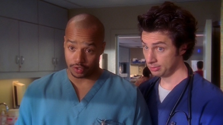 Donald Faison as Christopher Turk and Zach Braff as John Michael "J.D." Dorian standing next to each other on Scrubs