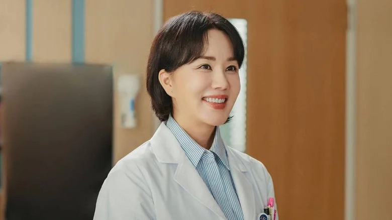 Cha Jeong-suk (Uhm Jung-hwa) smiles brightly in her hospital uniform in Doctor Cha