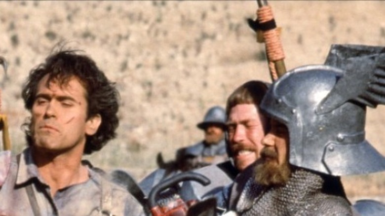 Ash (Bruce Campbell) surrounded by medieval knights in Army of Darkness