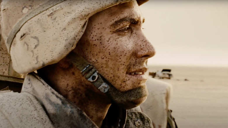 Jake Gyllenhaal as Corporal Anthony Swofford stands in the desert in Jarhead
