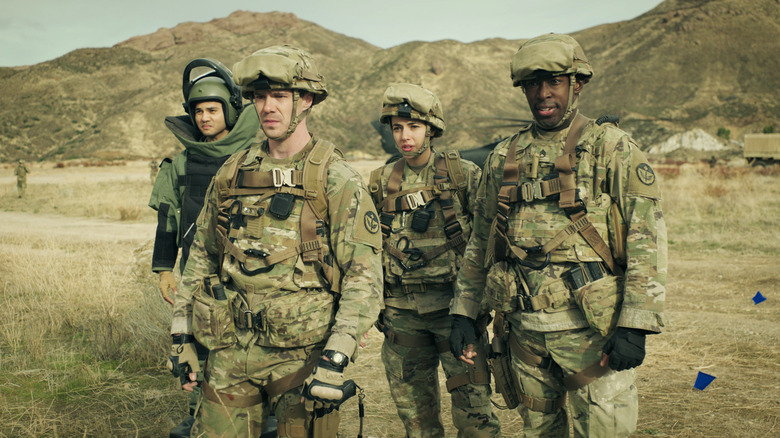 Lieutenant Silvera (Charles Maceo), Cooper Roback (Sam Keeley), Rosa Alvarez (Cristina Rodlo), and Mekhi Davis (Jeremy Tardy) stand on the battlefield in 68 Whiskey.