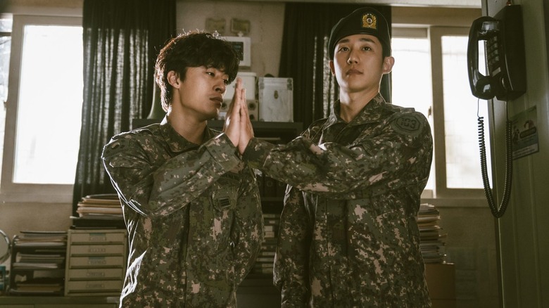 Han Ho-yul (Koo Kyo-hwan) and Ahn Joon-ho (Jung Hae-in) touch palms in "D.P."