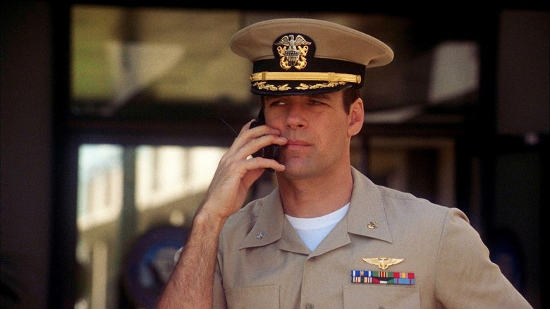 Lieutenant Harmon Rabb, Jr. (David James Elliott) takes a call in JAG.
