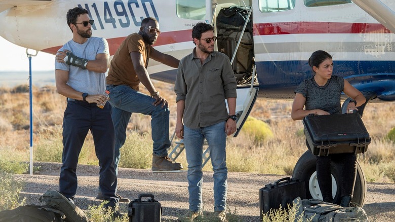 McG (Noah Mills), Preach (Demetrius Grosse), Amir Al-Raisani (Hadi Tabbal) and Jaz (Natacha Karam) stand near a plane in The Brave.