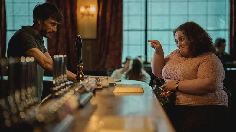 Martha Scott (Jessica Gunning) points at Donny Dunn (Richard Gadd) as he stands behind a bar in Baby Reindeer