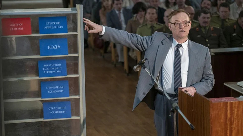 Valery Legasov (Jared Harris) points at a board with colored cards in Russian in Chernobyl
