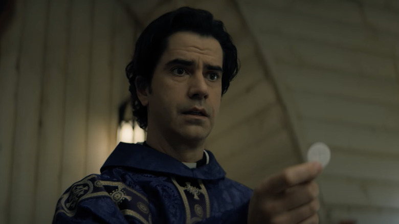 Paul Hill (Hamish Linklater) offers a communion wafer in Midnight Mass