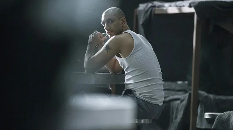 Naz Khan (Riz Ahmed) glances tensely while at a prison table in The Night Of