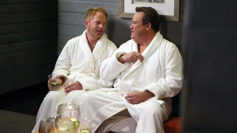 Jesse Tyler Fergusson and Eric Stonestreet as Mitchell and Cam sitting in a sauna on Modern Family