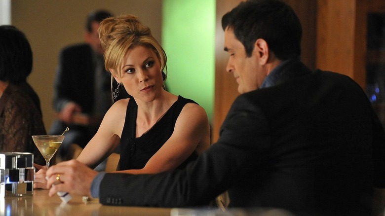 Julie Bowen and Ty Burrell as Claire and Phil sitting at a bar on Modern Family