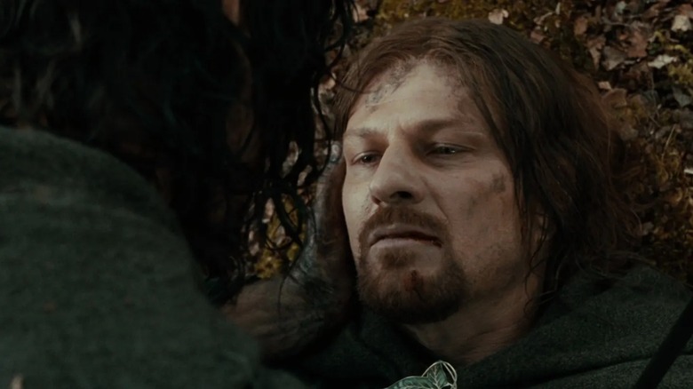 Aragorn (Viggo Mortensen) leans in to weep for Boromir (Sean Bean) In Lord of the Rings Fellowship of the Ring