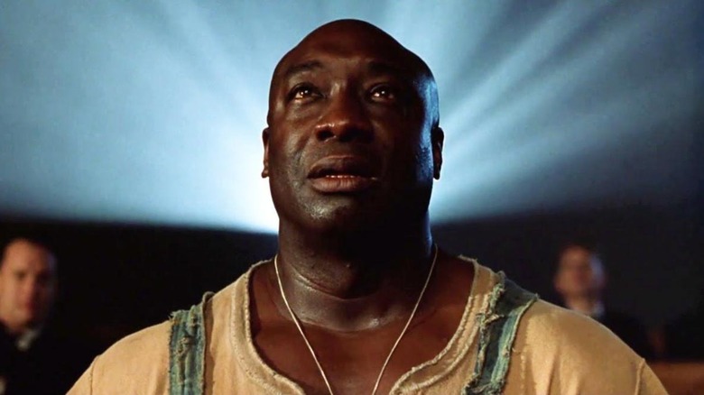Innocent and weeping, John Coffey (Michael Clarke Duncan) enjoys a movie on his last night in The Green Mile