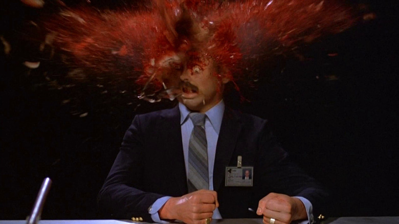 A man's head, split seconds before it gets gross, in Scanners
